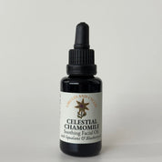 Black bottle of Celestial Chamomile soothing facial oil on a light gray background